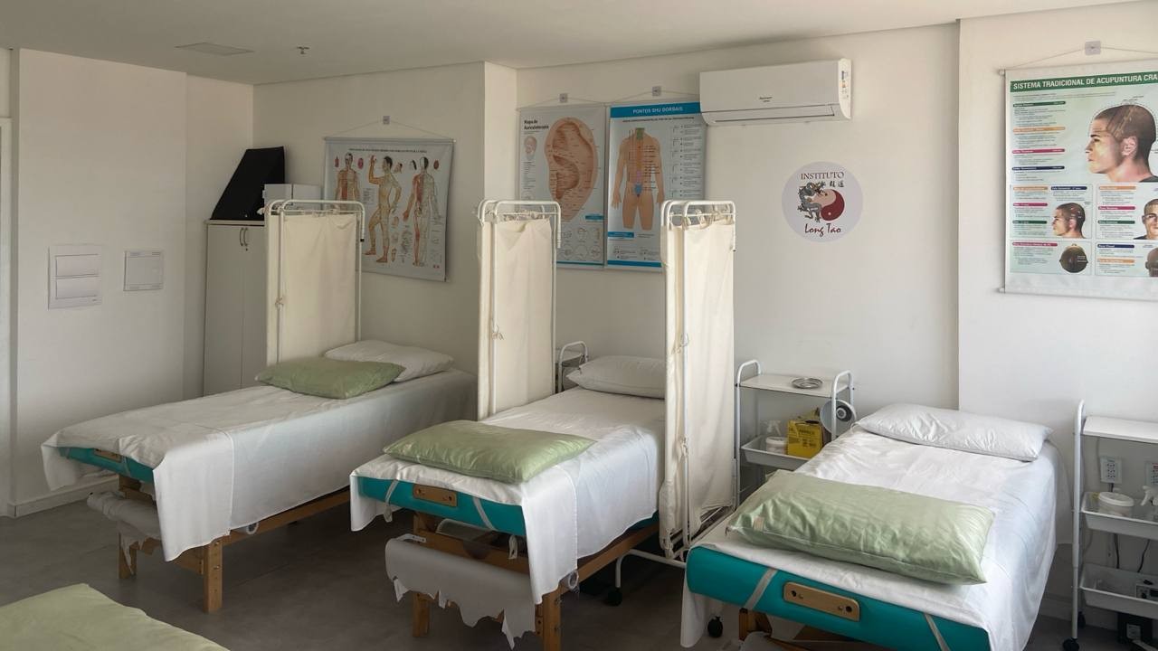 Macas do ambulatório com mapas de acupuntura e o logo do Instituto Long Tao